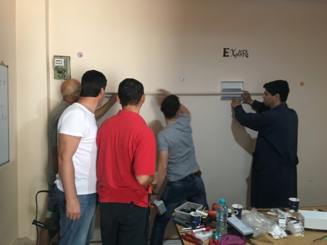 Electricienii la montajul unei instalatii electrice fac munca in echipa.JPG